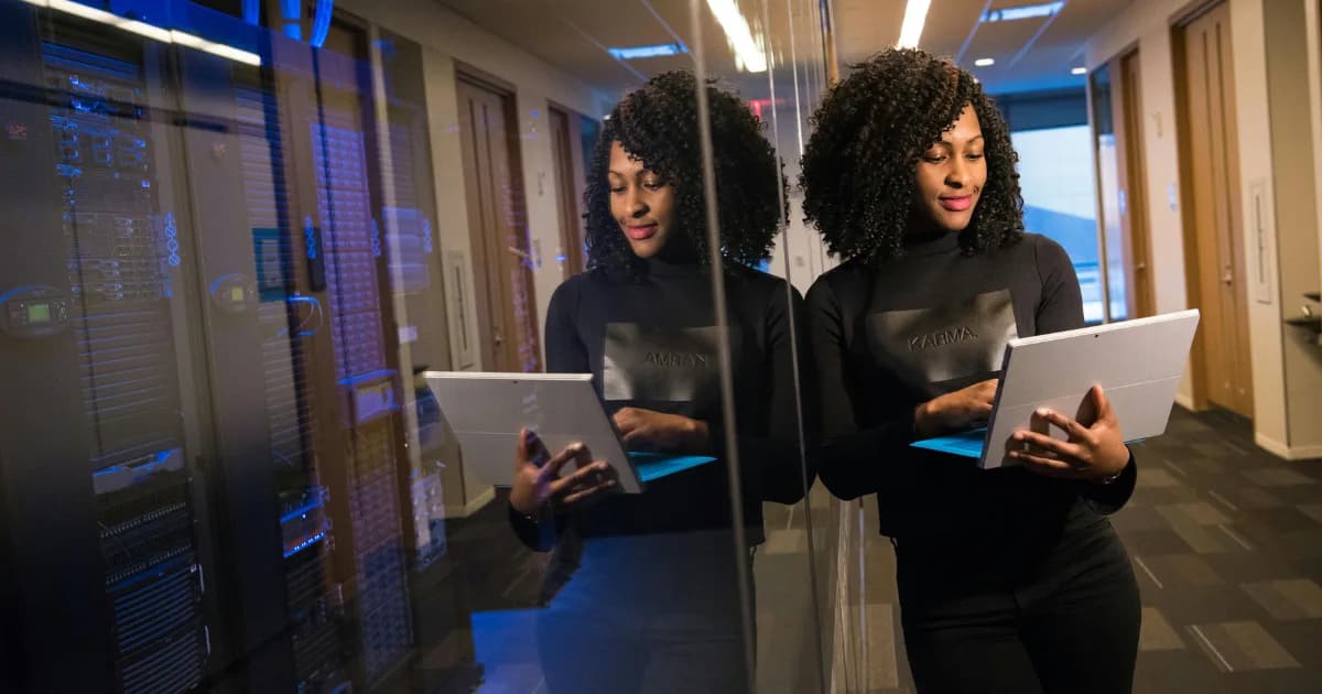 An administrator with a laptop in a server room
